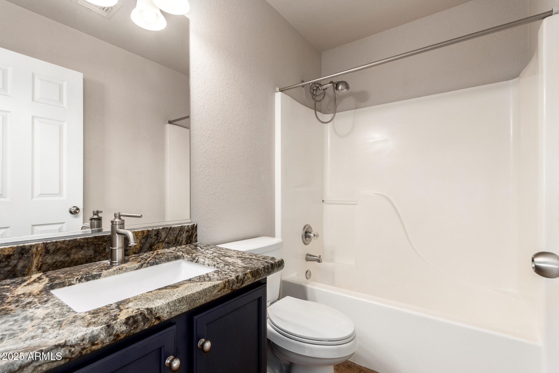 631 South Colonial Court Gilbert, AZ 85296 - Photo 21 of 27 a bathroom with a granite countertop sink a toilet and shower