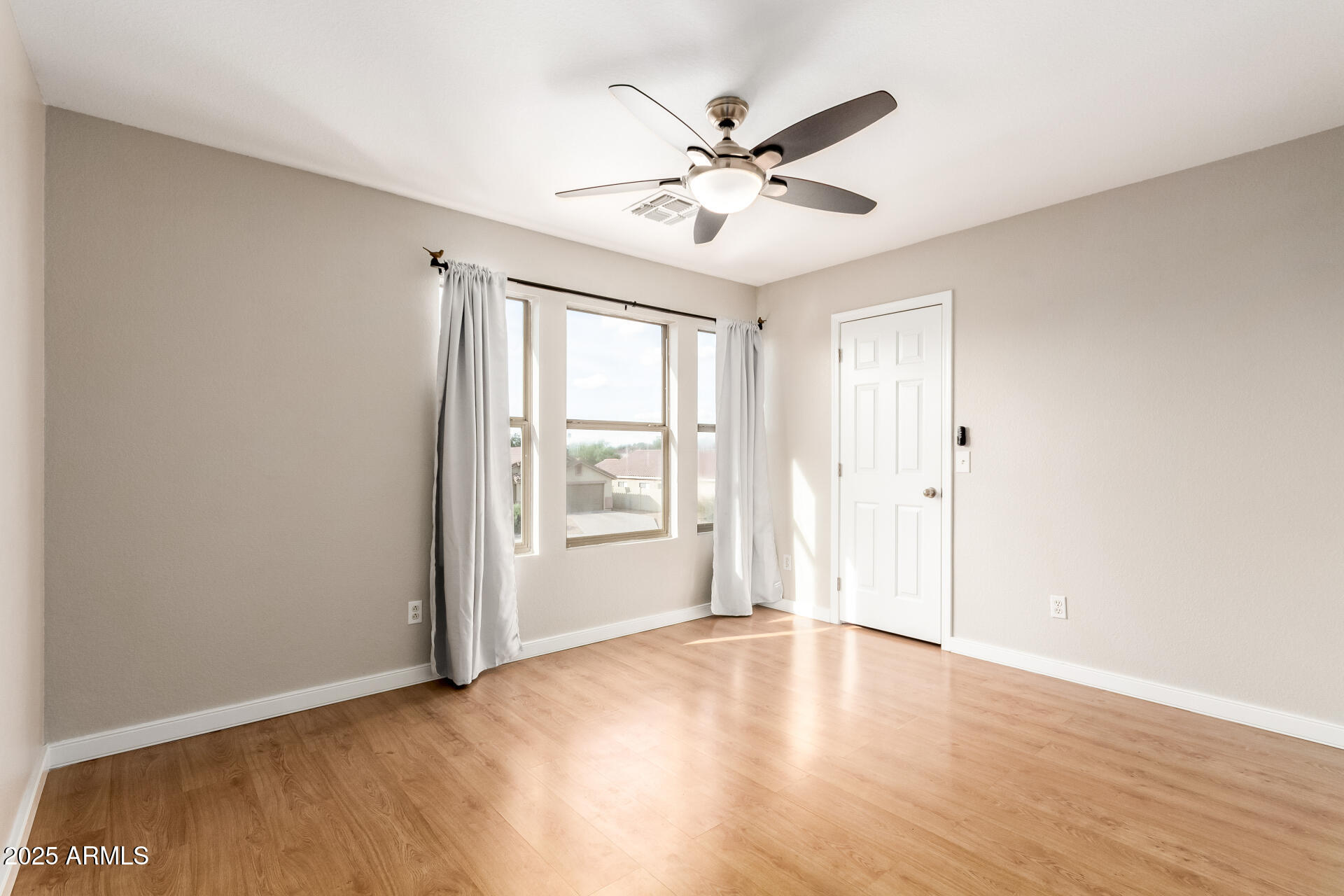 631 South Colonial Court Gilbert, AZ 85296 - Photo 22 of 27 a view of an empty room with wooden floor and a window