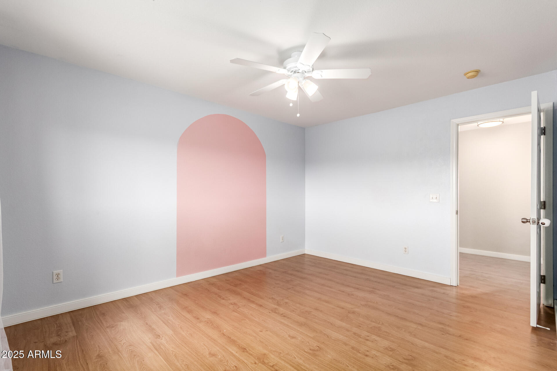 631 South Colonial Court Gilbert, AZ 85296 - Photo 23 of 27 an empty room with wooden floor and fan
