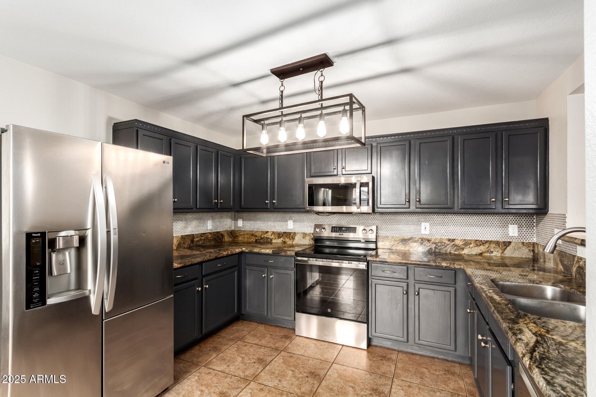 631 South Colonial Court Gilbert, AZ 85296 - Photo 10 of 27 a kitchen with stainless steel appliances granite countertop a sink a stove a refrigerator cabinets and a window