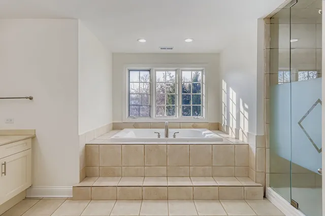 a bathroom with a bathtub and window