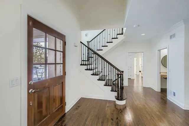 a view of entryway with wooden floor and stairs