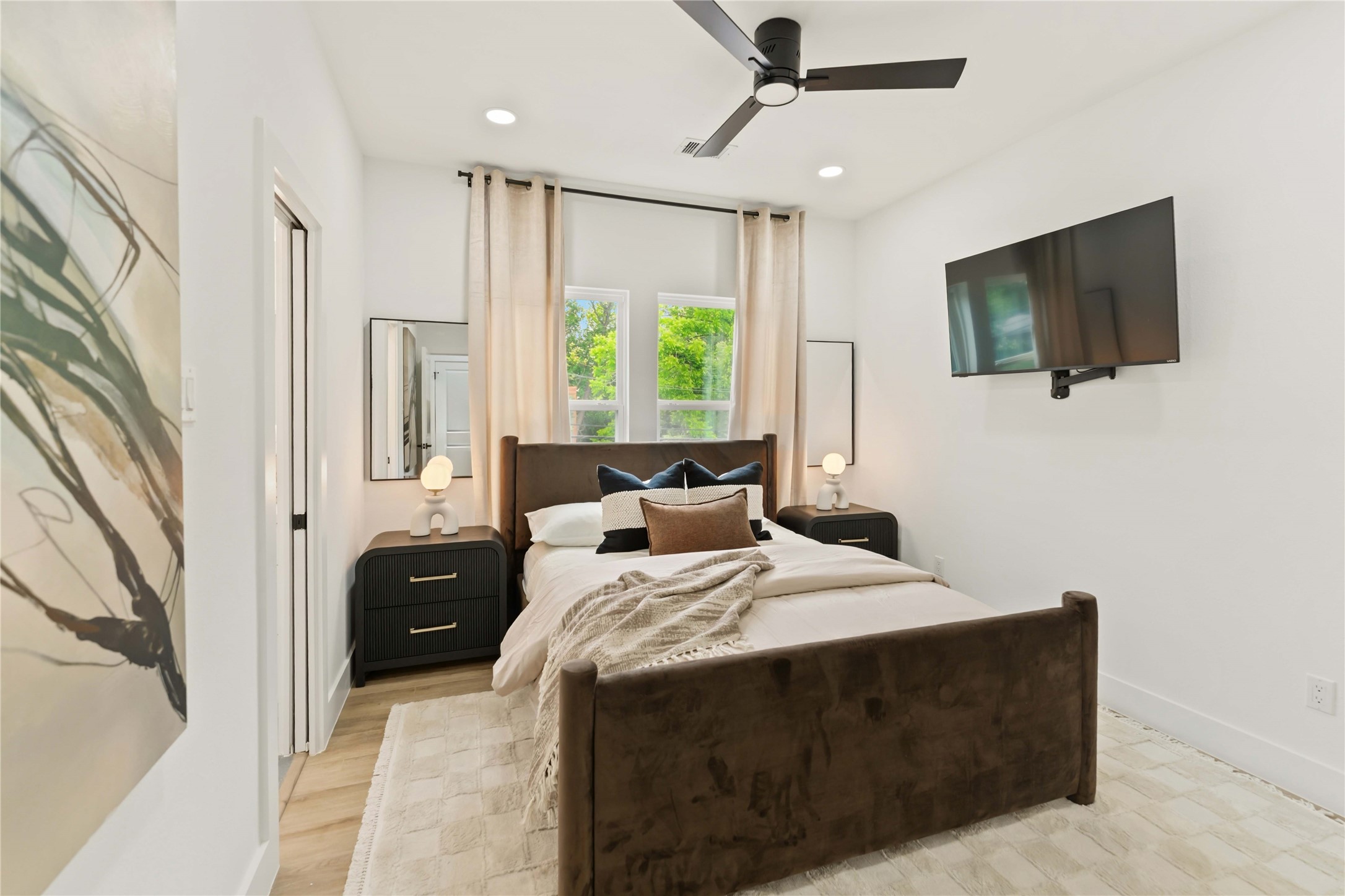6539 Sealey Street Houston, TX 77091 - Photo 23 of 28 a bedroom with a bed flat screen tv and a window