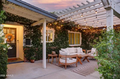 a view of a patio with table and chairs and potted plants