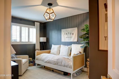 a bedroom with a bed and a chandelier