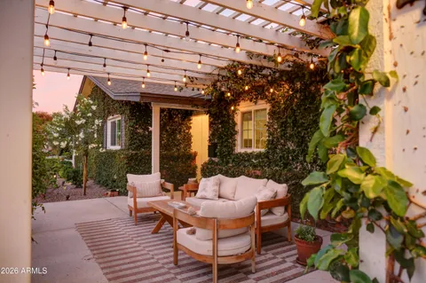 a view of a patio with table and chairs and potted plants