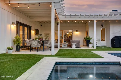 a view of a house with a swimming pool and a yard