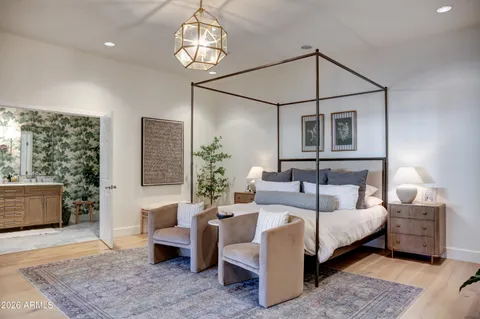 a bedroom with a bed a couch and dresser