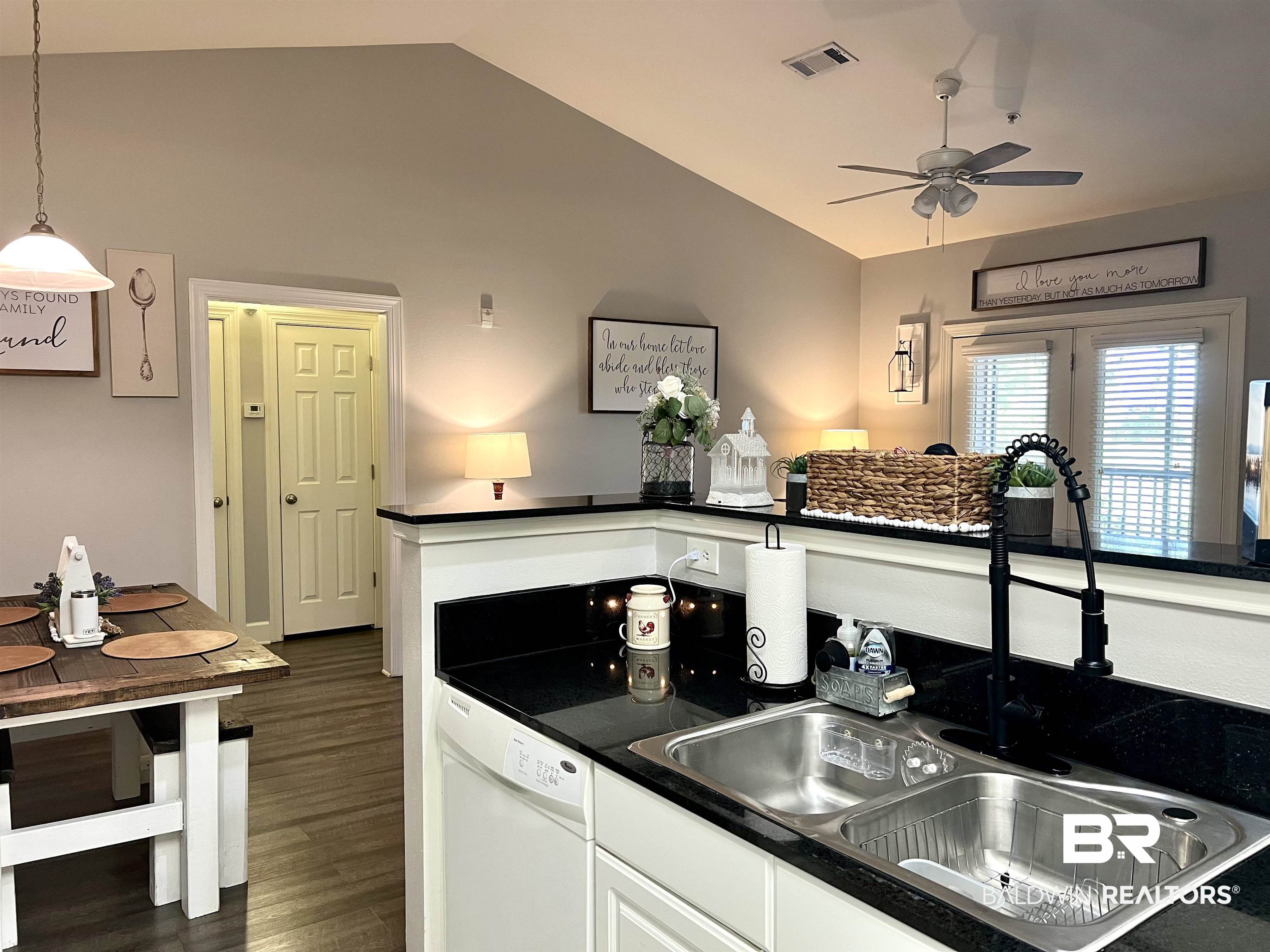 450 Park Avenue, Unit 808 Foley, AL 36535 - Photo 8 of 38 Kitchen with lofted ceiling, sink, white cabinetry, decorative light fixtures, and white dishwasher