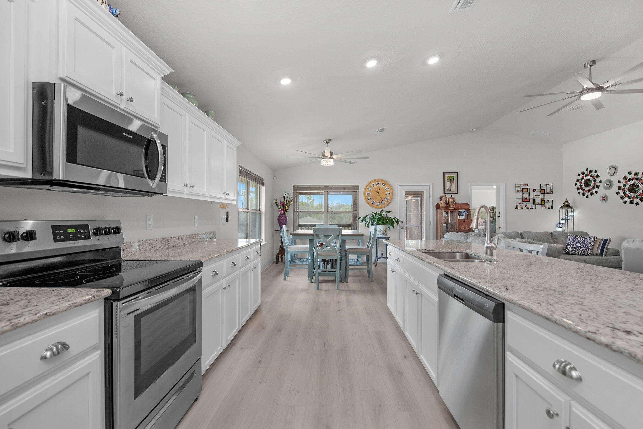 2099 Queen Street Crestview, FL 32536 - Photo 13 of 36 a kitchen with stainless steel appliances granite countertop a stove and cabinets