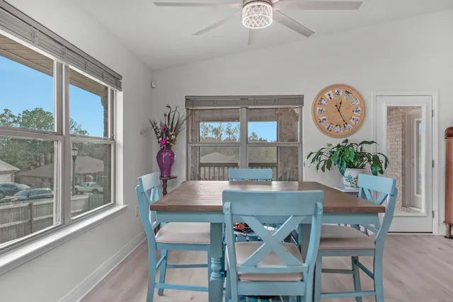 a dining room with furniture a potted plant and a chandelier
