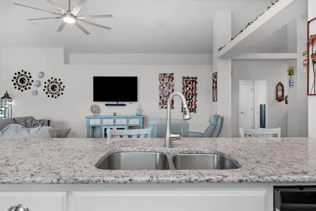 a kitchen with a sink and a mirror