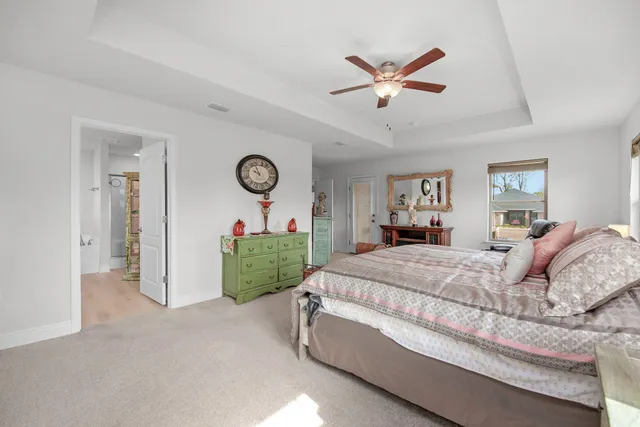 a bed room with a bed and a ceiling fan