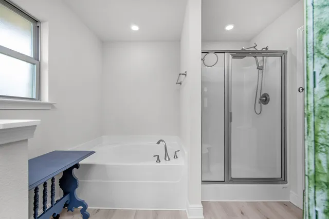 a white bath tub sitting next to a shower