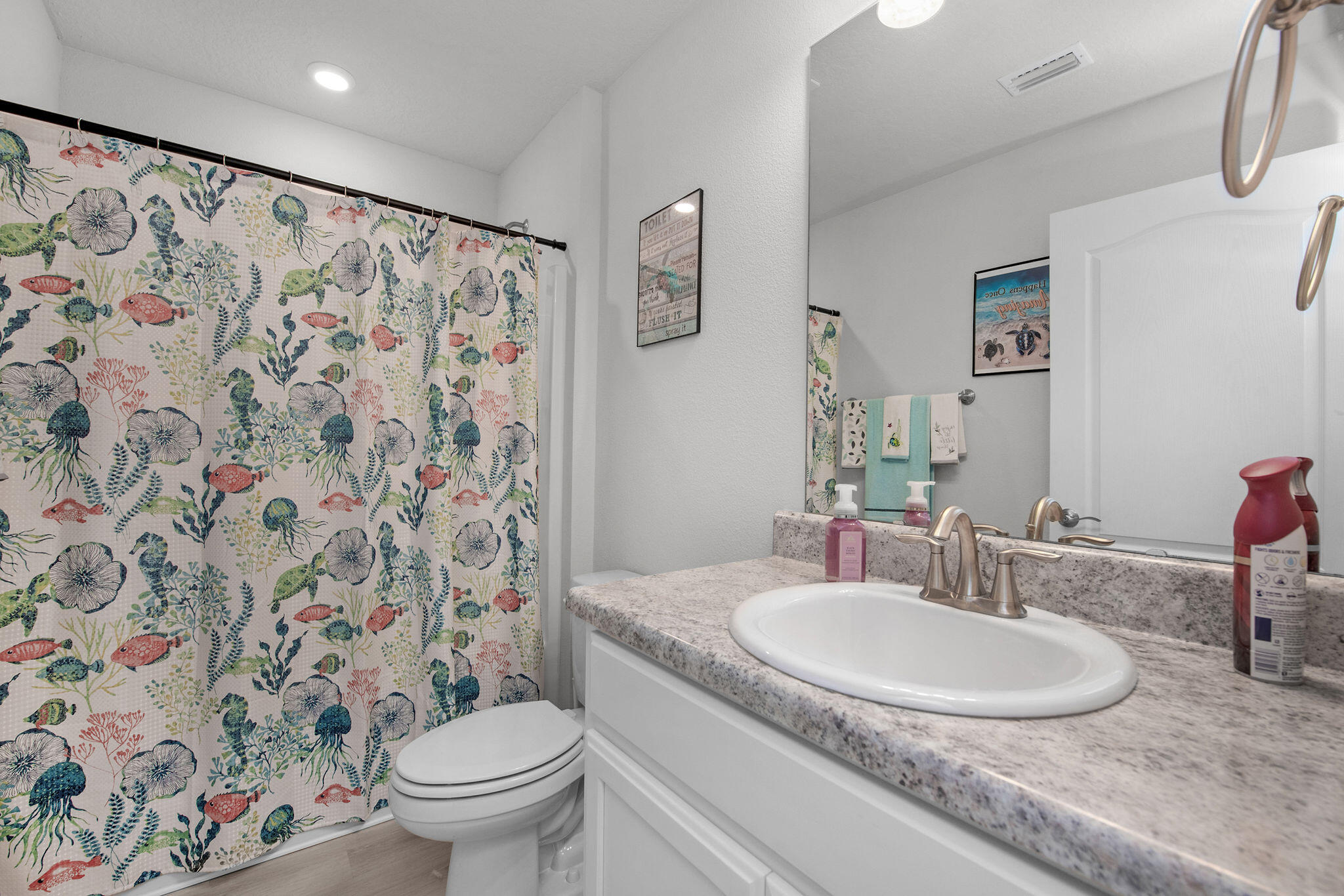 2099 Queen Street Crestview, FL 32536 - Photo 28 of 36 a bathroom with a granite countertop sink a toilet and a mirror