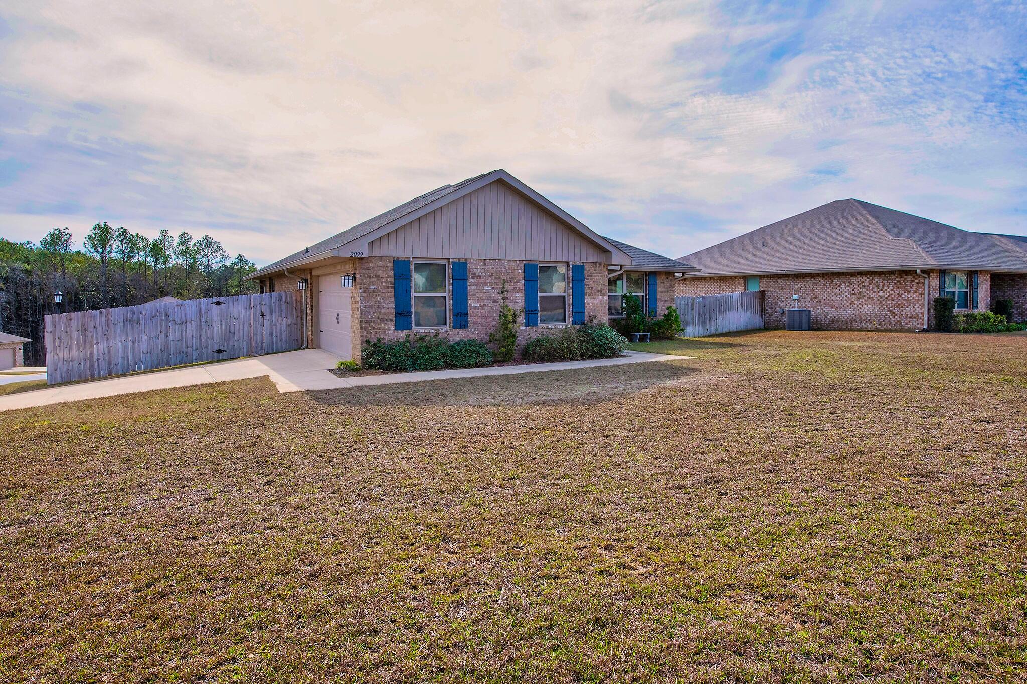 2099 Queen Street Crestview, FL 32536 - Photo 34 of 36 a front view of house with yard and trees