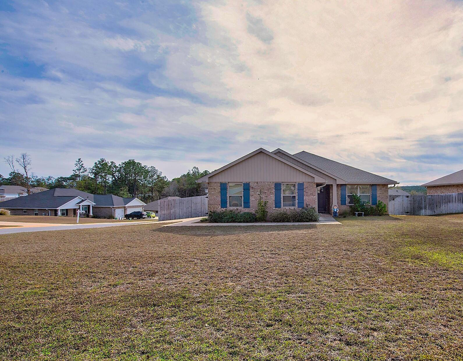 2099 Queen Street Crestview, FL 32536 - Photo 35 of 36 a front view of a house with a yard