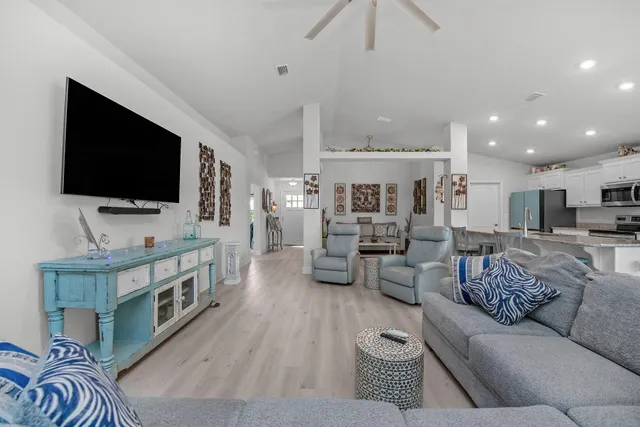 a living room with furniture and a flat screen tv