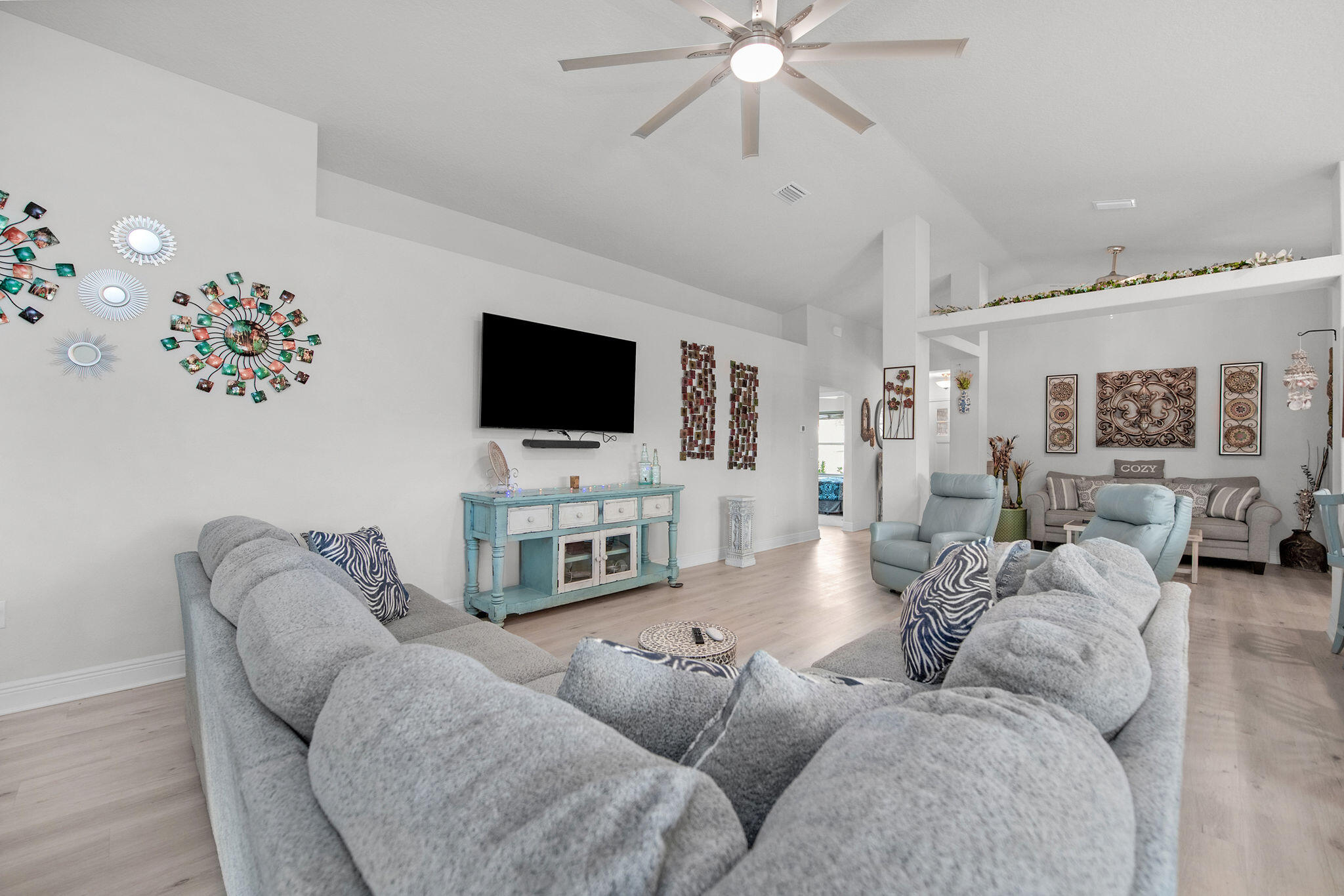 2099 Queen Street Crestview, FL 32536 - Photo 6 of 36 a living room with furniture a flat screen tv and a chandelier