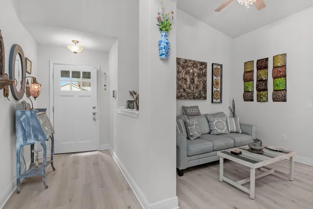 a living room with furniture a flat screen tv and a window