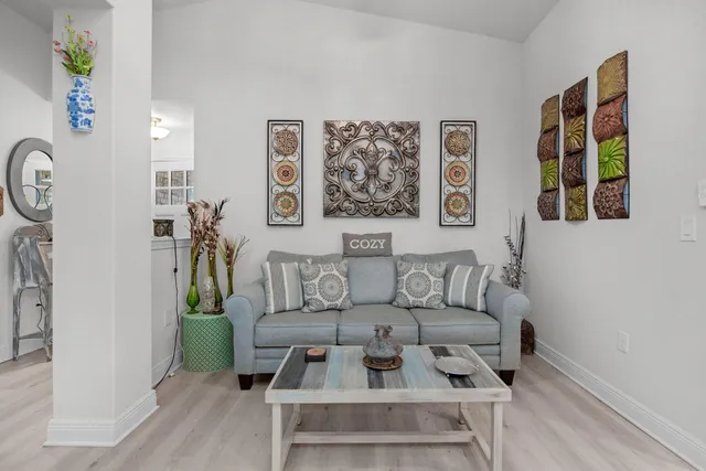 a living room with furniture and wooden floor