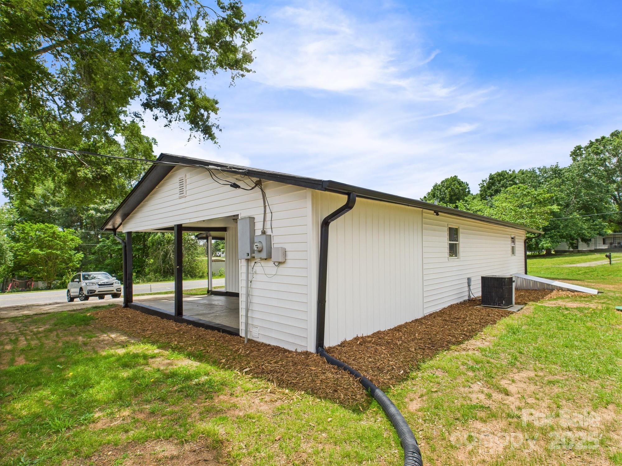120 Hepler Road Taylorsville, NC 28681 - Photo 4 of 20 a backyard of a house with wooden fence and large trees
