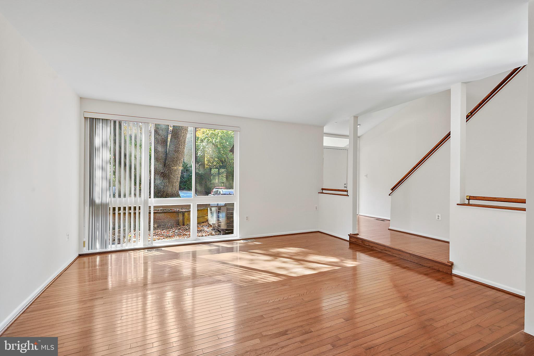 2006 Lakebreeze Way Reston, VA 20191 - Photo 14 of 49 a view of an empty room with wooden floor and a window