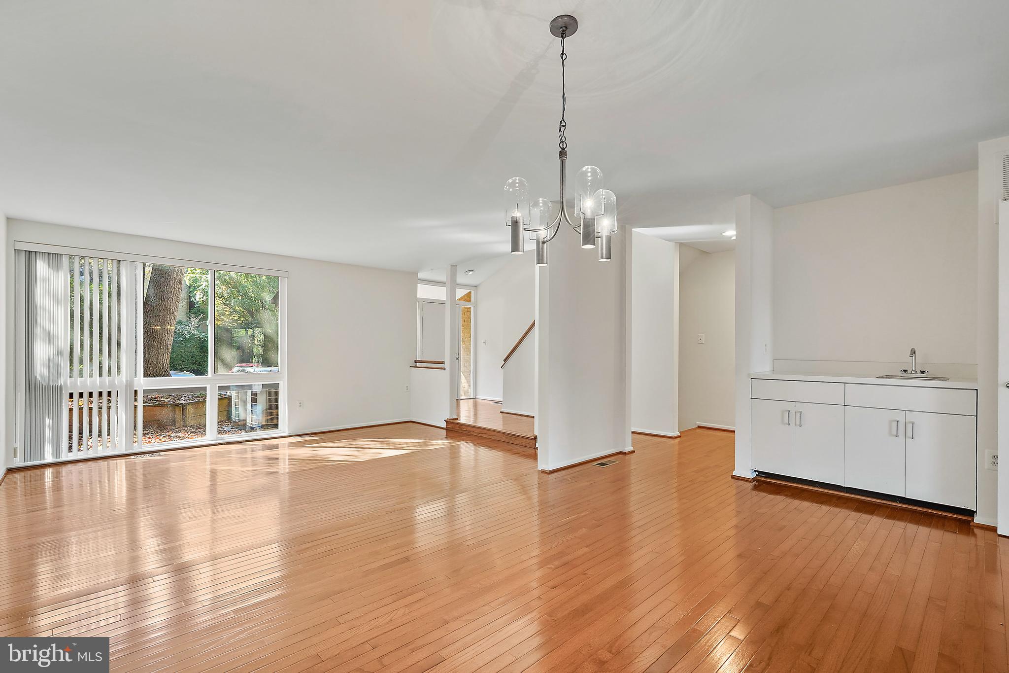 2006 Lakebreeze Way Reston, VA 20191 - Photo 17 of 49 a view of an empty room with wooden floor and a window