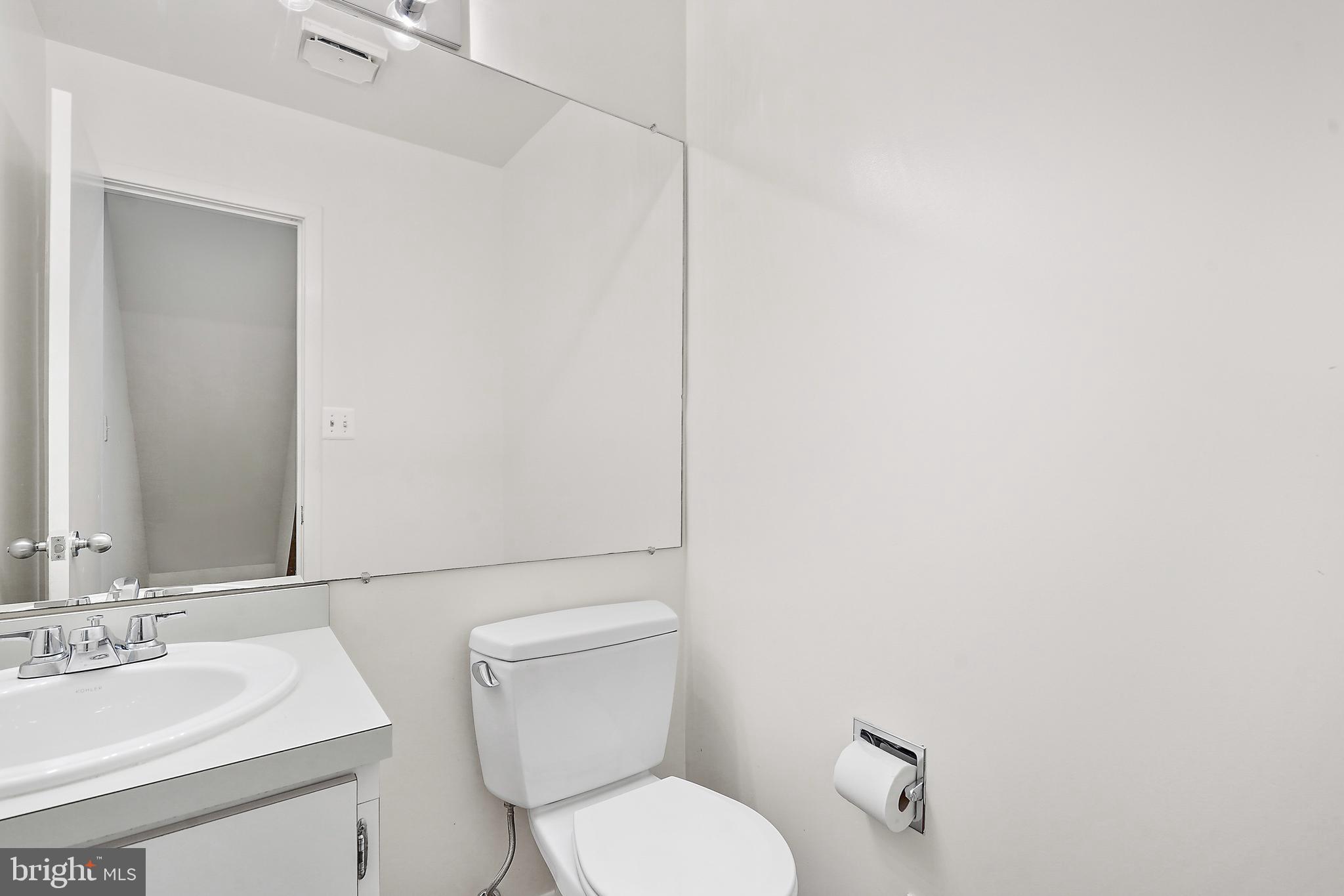 2006 Lakebreeze Way Reston, VA 20191 - Photo 23 of 49 a white toilet sitting next to a bathroom sink