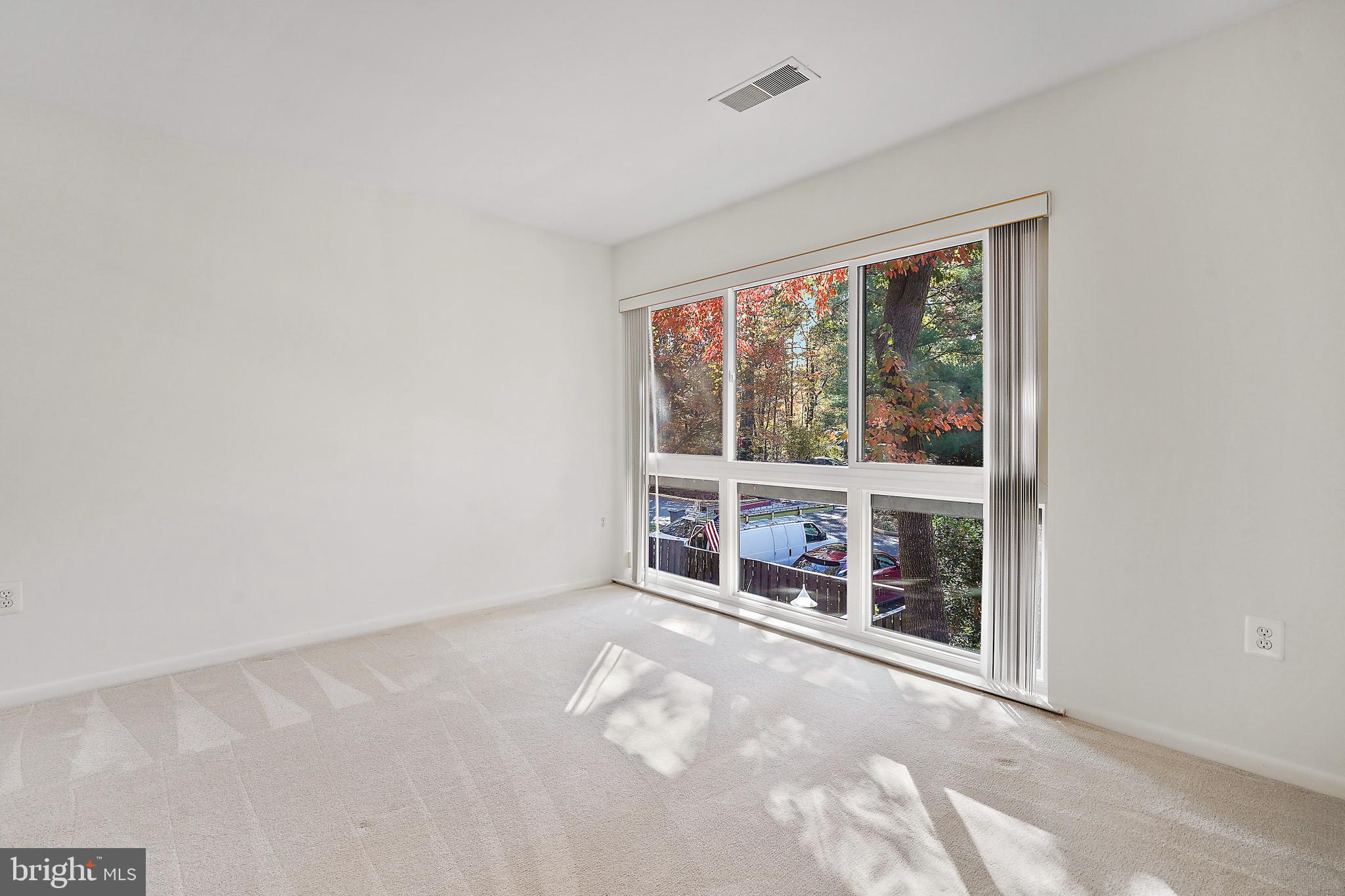 2006 Lakebreeze Way Reston, VA 20191 - Photo 36 of 49 an empty room with floor to ceiling window and an outdoor space
