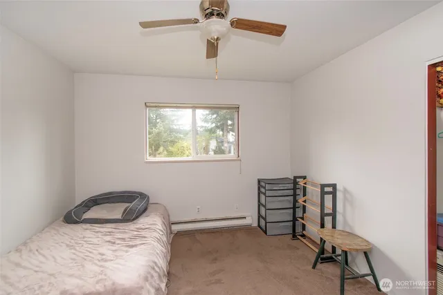 a bedroom with a bed and a chair