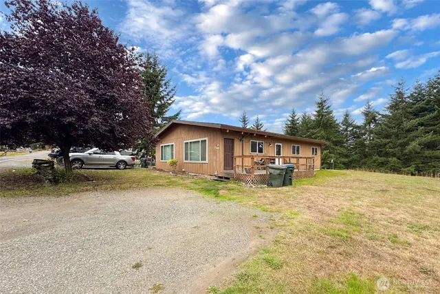 a view of a house with pool and a yard