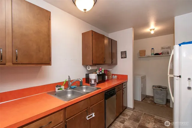 a kitchen with stainless steel appliances a sink stove and refrigerator