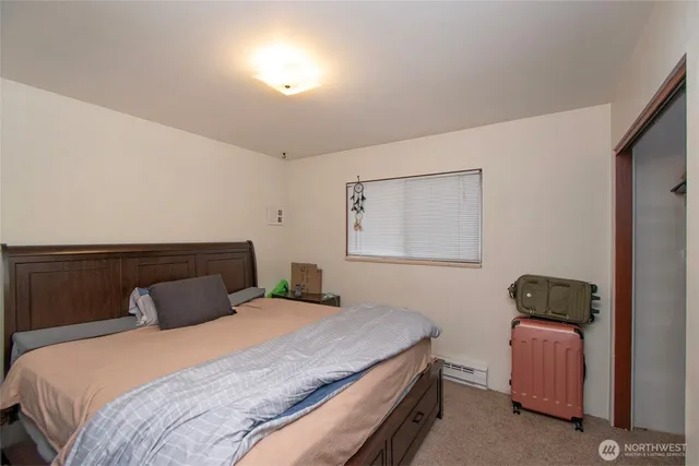 a bedroom with a bed and a lamp with window