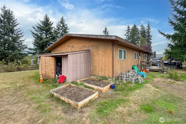 a view of a backyard with plants and lake view