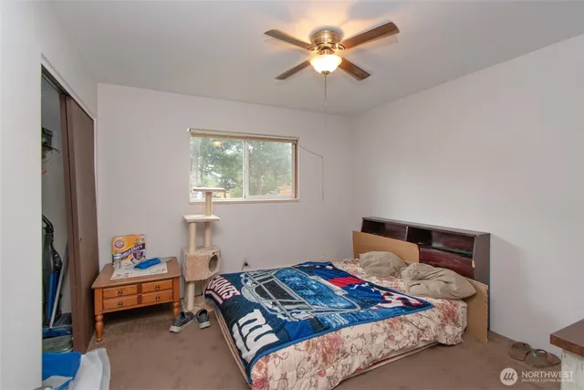 a bedroom with a bed and a chandelier