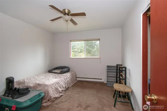 a bedroom with a bed and a window