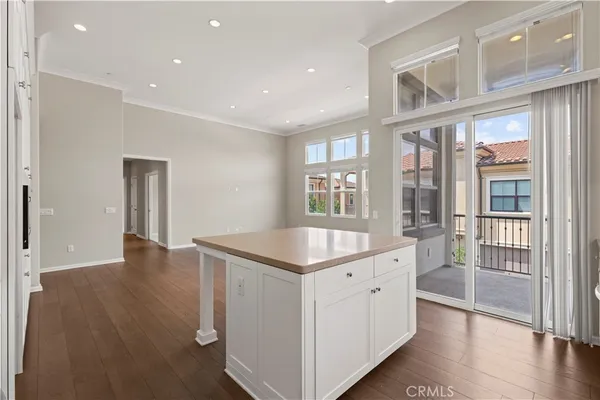 a hallway with windows and chandelier