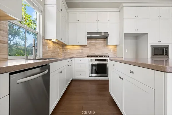 a kitchen with appliances cabinets and a sink