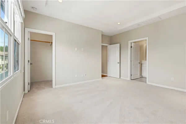 an empty room with closet and a bathroom