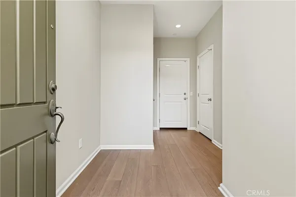 a view of a hallway with wooden floor