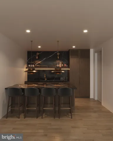 a kitchen with kitchen island a stove a sink and a refrigerator with wooden floor