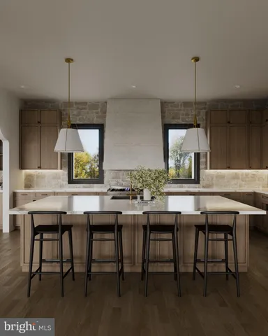 a kitchen with stainless steel appliances kitchen island granite countertop a table chairs and a wooden floor