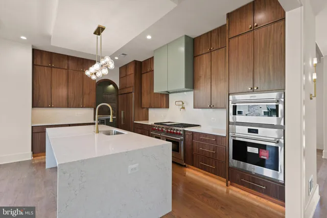 an empty room with wooden floor and a fireplace