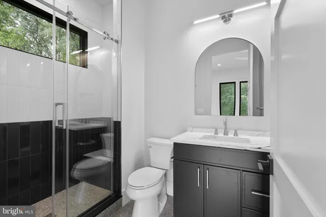 a bathroom with mirror a sink and vanity