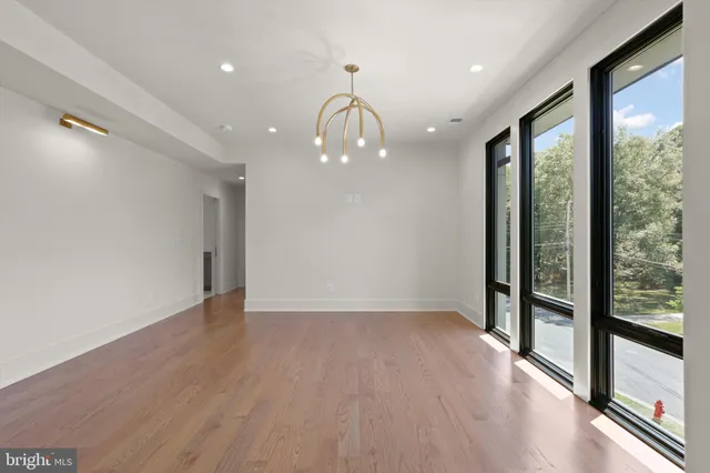 an empty room with window and a view of room