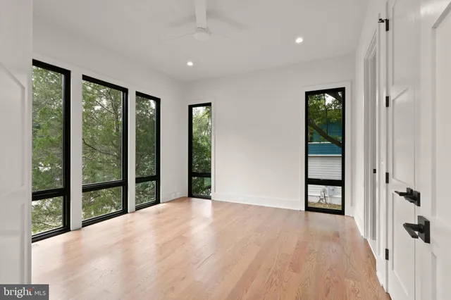 an empty room with window and a view of room