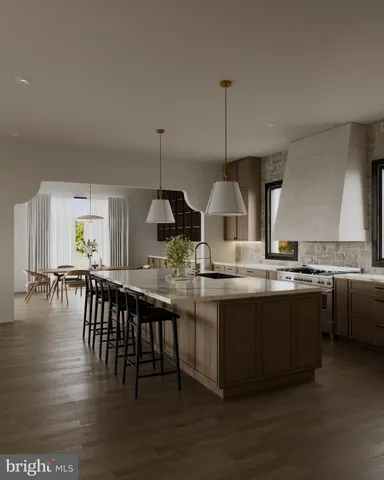 a kitchen with stainless steel appliances granite countertop a sink a stove and chairs