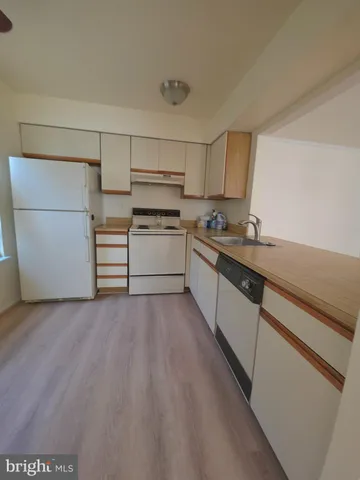 a kitchen with a sink a stove and cabinets