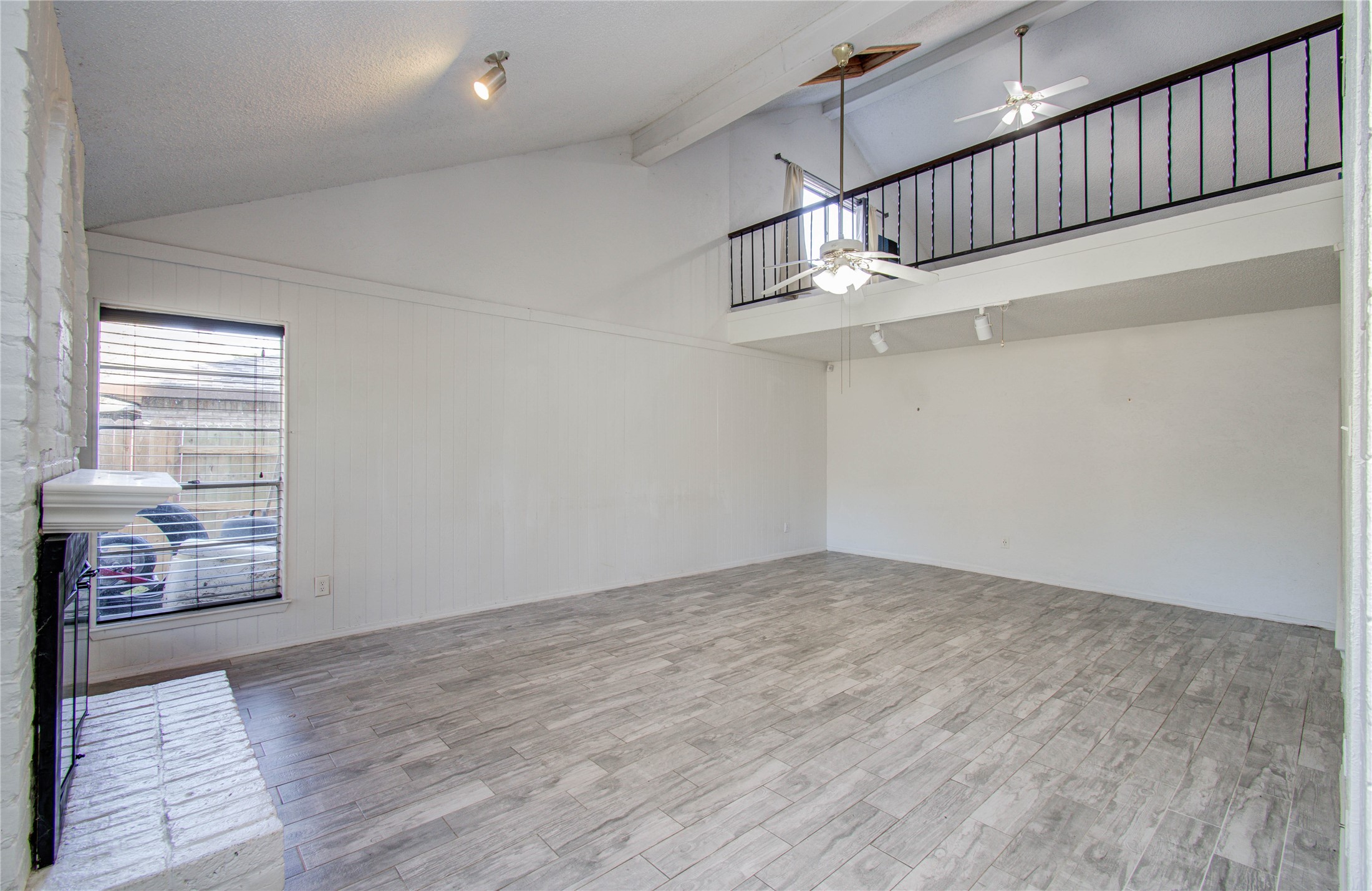 5311 Sweetwind Lane Spring, TX 77373 - Photo 3 of 18 a view of an empty room with wooden floor and windows
